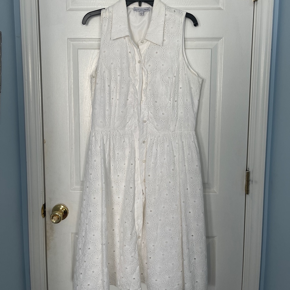 White, sleeveless, eyelet dress. Buttons down the front.